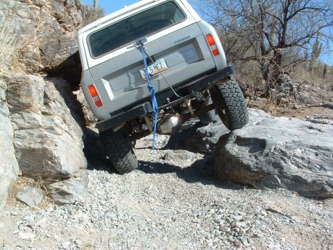 1981 Ford F-150 - Vehicle attempts to climb over large rocks on a trail.