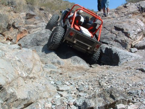 1981 Ford F-150 - An off-road vehicle navigates a challenging rocky incline, its off-road capabilities.