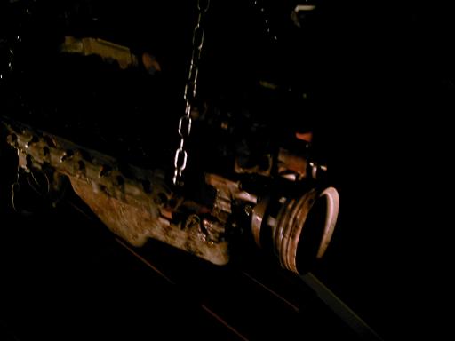 Engine component with chains, dark background