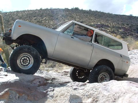 1981 Ford F-150 - An International Scout II is shown tackling a challenging rocky trail in a desert environment.