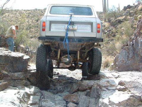 1981 Ford F-150 - This off-road vehicle navigates a challenging rocky terrain, with a person observing its progress.