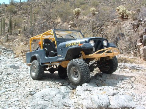 1981 Ford F-150 - This Jeep CJ-8 Scrambler is navigating a rocky, desert landscape.