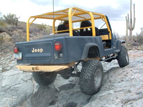 1981 Ford F-150 - This Jeep CJ-7 navigates a challenging rocky trail, its off-road capabilities.