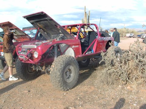 1981 Ford F-150 - This heavily modified off-road vehicle, possibly a Bronco, is shown with its hood open in a desert environment.
