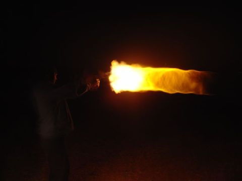 1981 Ford F-150 - A person fires a handgun, producing a bright muzzle flash and a trail of fire in the darkness. Supermotors.net logo is visible.