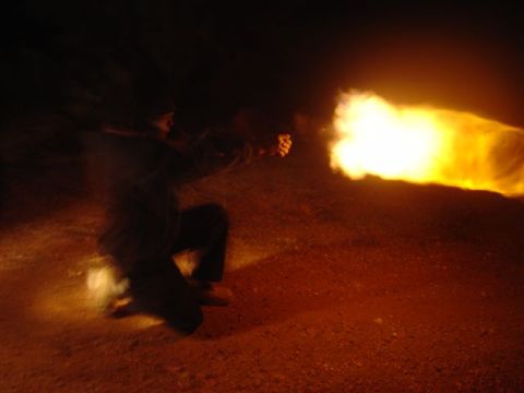 1981 Ford F-150 - A person fires a flamethrower, creating a large burst of flame against a dark background.
