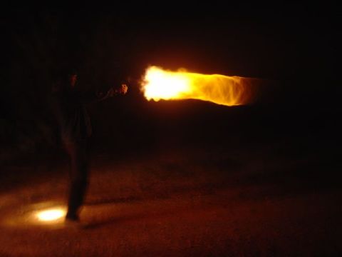 1981 Ford F-150 - A person is seen firing a flamethrower, creating a large plume of fire against a dark background.