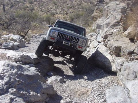 1981 Ford F-150 - An International Scout II tackles a challenging rocky trail, demonstrating its off-road capabilities.