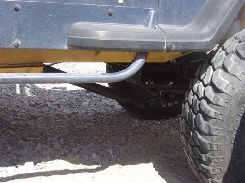1981 Ford F-150 - Close-up view of the side step and aggressive tire tread on a Jeep Wrangler.