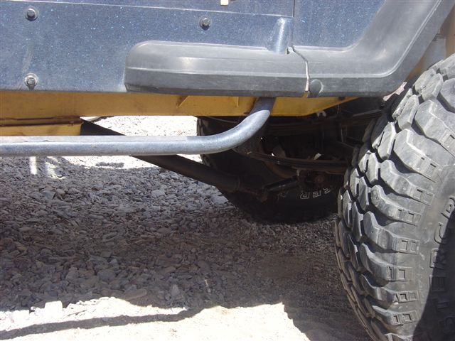 Side view of a Jeep Wrangler's step and large off-road tire