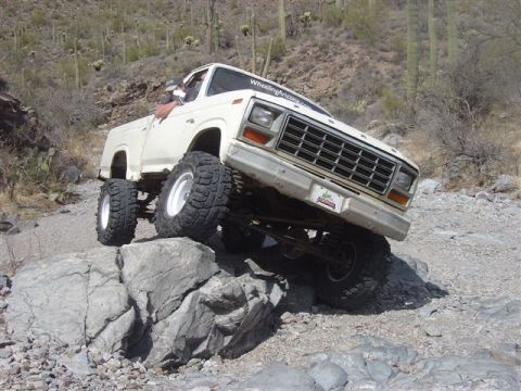 1981 Ford F-150 - This modified 1980 Ford F-150 navigates a rocky trail with large off-road tires.