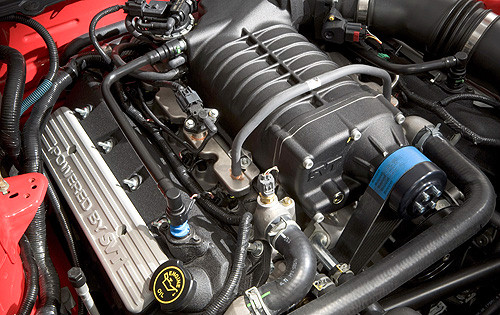 Supercharged engine with "POWERED BY SVT" valve cover and black intake manifold