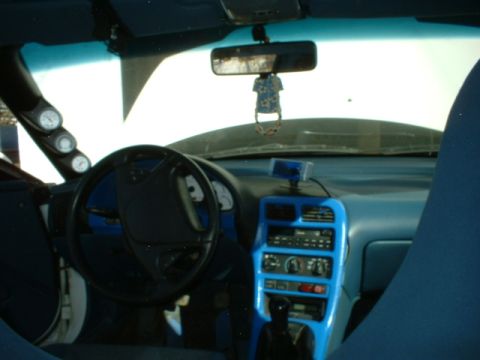 1993 Ford Probe - Car interior with blue trim and aftermarket gauges visible.