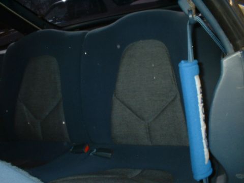 1993 Ford Probe - The rear seats of the car are upholstered in a blue and gray fabric with a distinctive pattern.