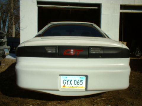 1993 Ford Probe - Rear view of a white car with a prominent red GT badge and license plate GYX 065.