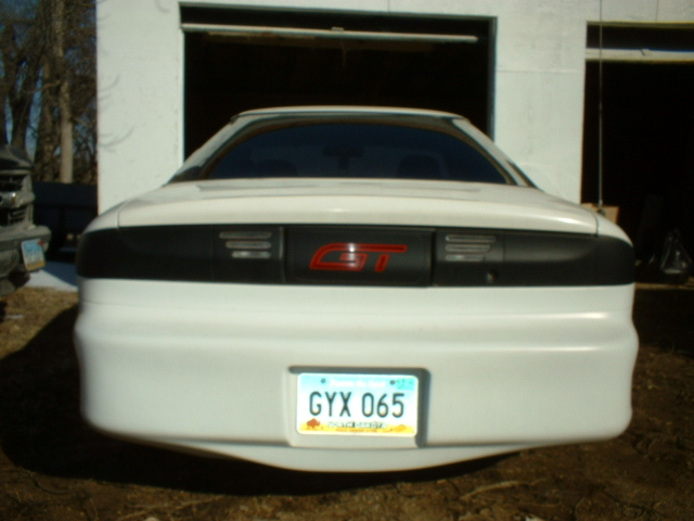 White car rear with GT badge and license plate GYX 065