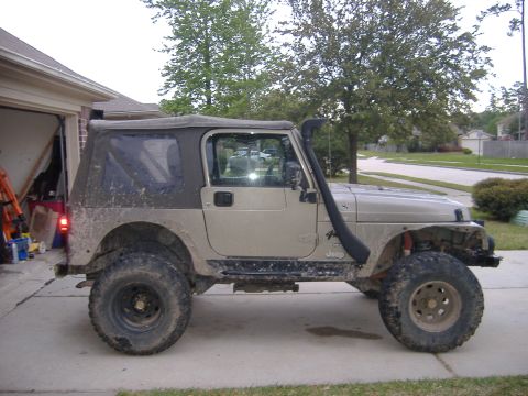 2004 Jeep Wrangler - This Jeep Wrangler is equipped with a snorkel and large off-road tires, suggesting it's ready for adventure.