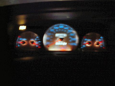 1985 Mercury Grand Marquis - The illuminated dashboard gauges show a digital odometer and various warning lights.