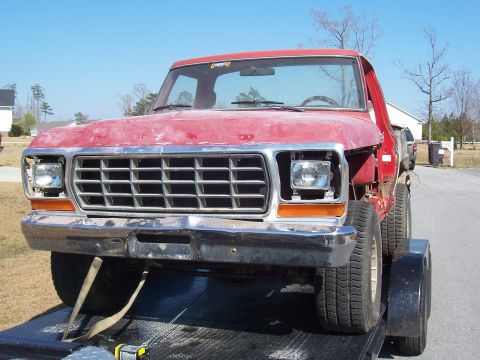 1978 Ford Bronco - This red 1979 Ford F-150 pickup truck is being transported on a trailer.