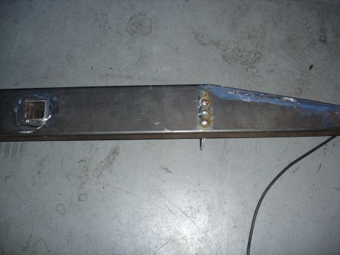 1996 Ford Bronco - Welded metal frame part with a square hole and visible welds.