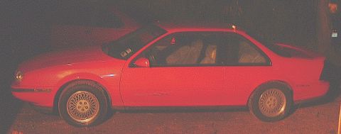 1991 Chevrolet Beretta - Side view of a red 1991 Chevrolet Beretta coupe, matching the registry claim.