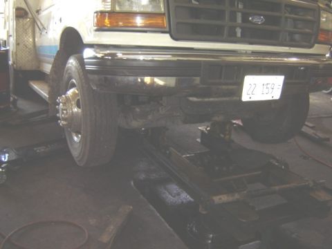 1992 Ford Bronco - A 1992 Ford Bronco is shown on a lift in a garage, viewed from the front.