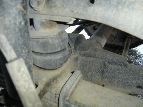 1988 Ford Bronco - Undercarriage view of suspension parts, showing rubber bump stops and metal components.