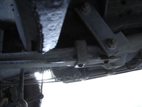 1988 Ford Bronco - Close-up of the undercarriage, showing suspension components and a tire tread.