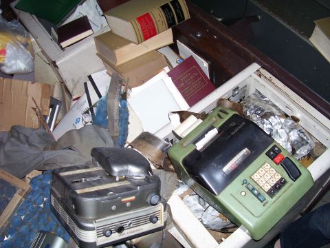 1992 Ford Bronco - A disorganized space filled with old electronic devices, books, and various other items.