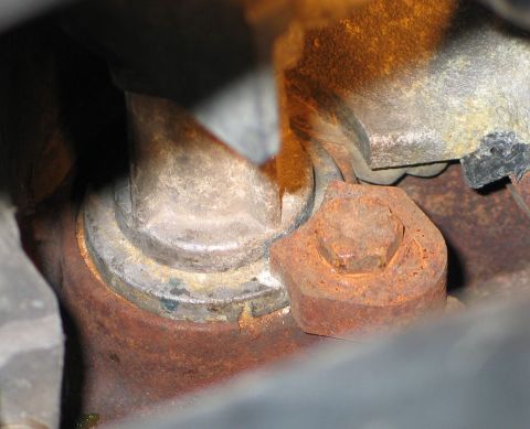 1994 Ford Bronco - Close-up of a rusted bolt and bracket, likely from an engine or chassis component.