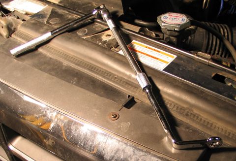 1994 Ford Bronco - Tools are laid out in the engine bay of a vehicle, suggesting maintenance or repair work.