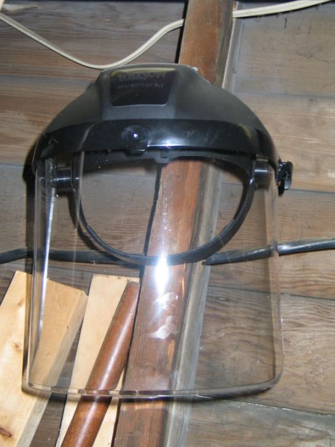1994 Ford Bronco - Face shield hanging on a wooden wall.