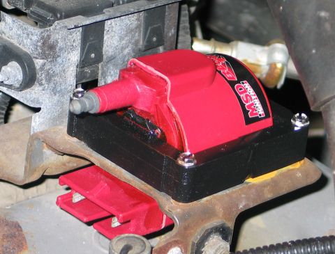 1994 Ford Bronco - A red MSD ignition coil is shown mounted on a black bracket, with visible text indicating 'MSD IGNITION'.