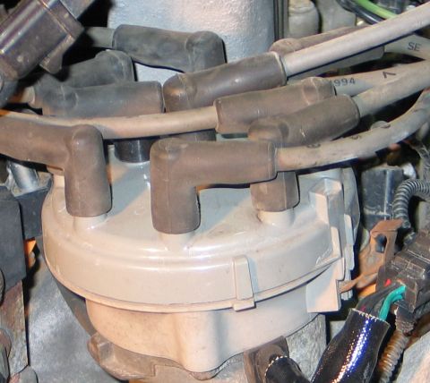 1994 Ford Bronco - Distributor cap and spark plug wires, one wire is marked with '1994'.