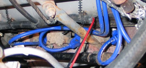 1994 Ford Bronco - Close-up view of blue ignition wires and a red wire bundle, likely from an engine compartment.