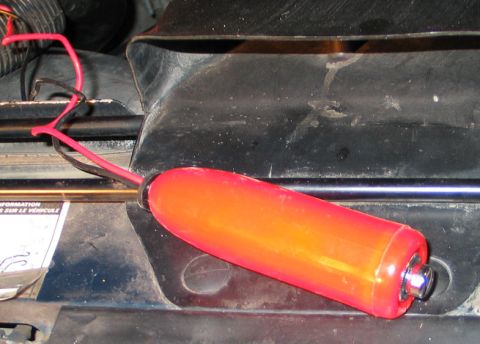 1994 Ford Bronco - Close-up of a red ignition coil and wiring, likely in an engine bay.