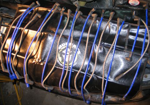 1994 Ford Bronco - Spark plug wires are visible over a black cover with a logo.