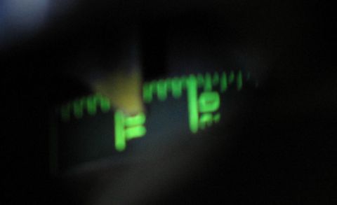 1994 Ford Bronco - Close-up of a vehicle's illuminated dashboard gauge cluster at night.