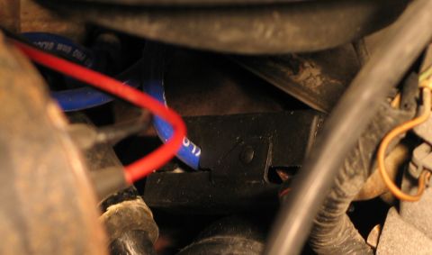 1994 Ford Bronco - Close-up view of engine components, including a blue hose and red wire.