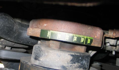 1994 Ford Bronco - A close-up view of an engine component with a measuring tape indicating a reading between 40 and 50.