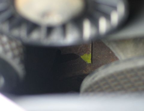 1994 Ford Bronco - A close-up view of a vehicle's mechanical components, showing rust and a yellow marking.