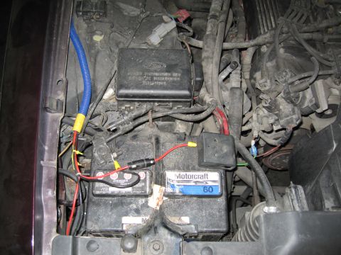 1992 Ford Crown Victoria - Close-up of a car battery and engine wiring, showing a Motorcraft 60 battery.