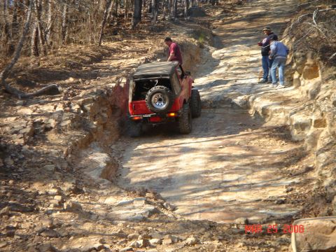 1978 Ford Bronco - Off-roading adventure on a challenging dirt path with onlookers.