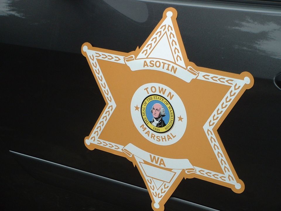 Town Marshal badge with 'ASOTIN' and 'WA' on a dark vehicle