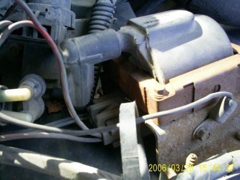 1994 Ford Bronco - Close-up view of engine components, including an ignition coil and distributor cap.
