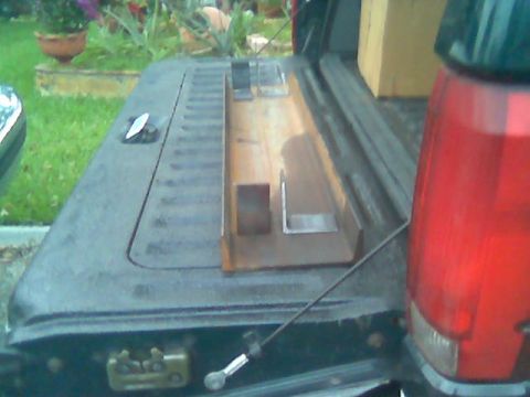 1992 Ford Bronco - Metal parts are secured in the bed of a pickup truck, with a red taillight visible on the right.