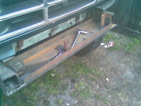 1992 Ford Bronco - The front bumper area of a vehicle is shown with tools laid out, suggesting ongoing work.