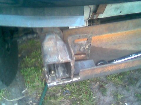 1992 Ford Bronco - Close-up of a custom winch mount being installed on a vehicle frame.