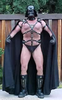 1991 Ford Bronco - Man dressed as Darth Vader stands outdoors in front of a wooden fence.