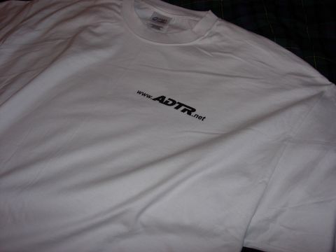 1998 Ford Crown Victoria - white T-shirt laid on a plaid surface with a small black www.ADTR.net logo printed on the chest.